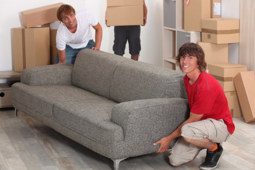 Commercial movers handling desks and IT equipment during an office relocation